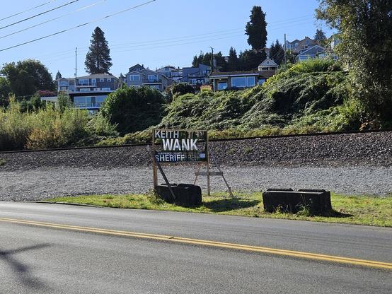 Keith Swank for Sheriff sign altered with cutouts before and after the "wank".