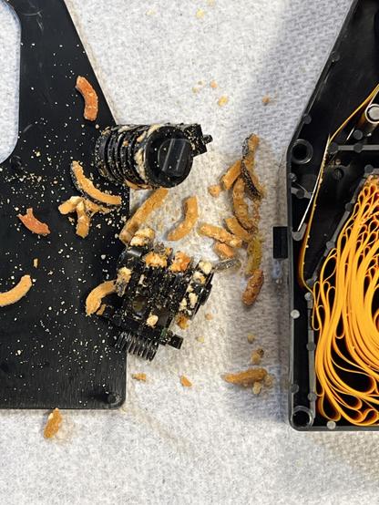 Two ImageWriter II color ribbon pinch rollers removed with crumbled foam bits everywhere. 