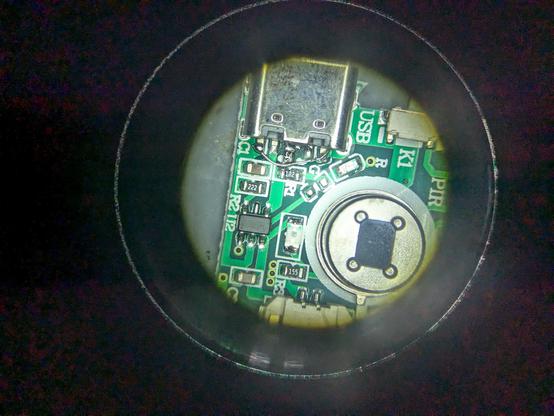 A shot through the microscope of a 6 pin usb c port with a single 5.1k resistor soldered to the CC pins and GND 