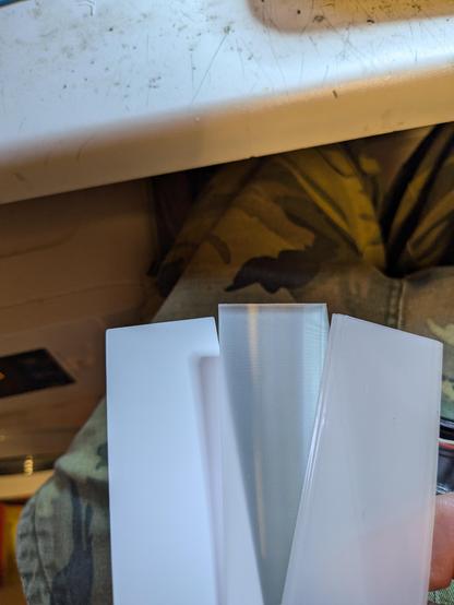3 defuser strips held in the hand, used to spread the light that comes from a led strip mounted in the side of the strip 