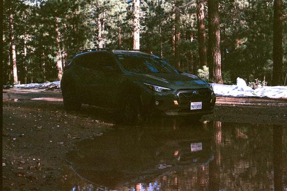 A car driving through a mud puddle