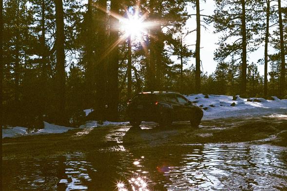 A car driving through a mud puddle