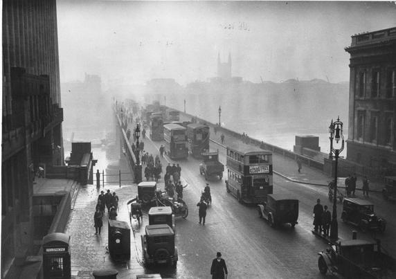 lots of traffic on a foggy bridge