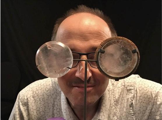 A portrait of SellaTheChemist peering through the rock salt windows that he used when he demonstrated the "diathermancy" of different gases and in doing so establishing why water and CO2 are greenhouse gases. 