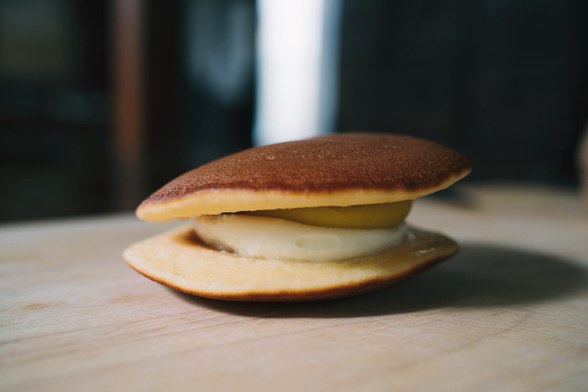 a pancake treat with sweet potato puree and whipped cream sits on a table 