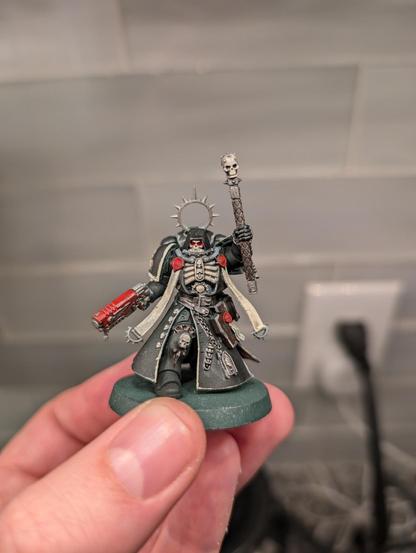 A Warhammer mini, space marine chaplain, freshly painted