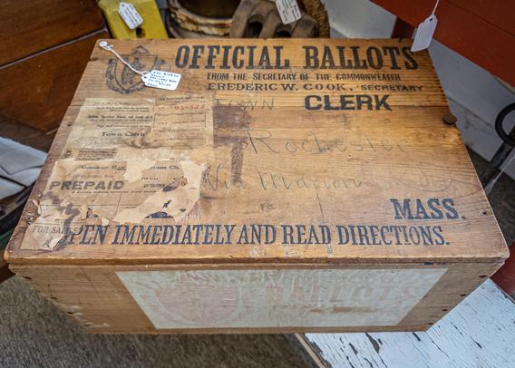 A photograph of an antique ballot box (this one once delivered boxes of ballots from the Commonwealth of Massachusetts to the town of Rochester.)