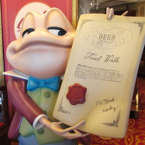 Statue of Mr. Toad holding the deed to Toad Hall at Walt Disney World