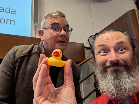 a small yellow rubber duck and two grinning idiots.