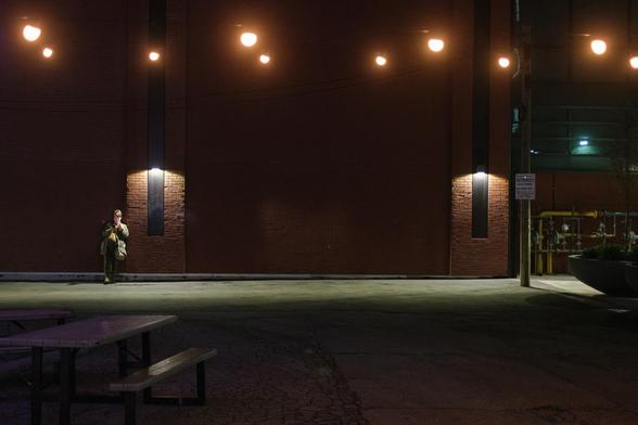 a lone figure against the back wall of Raccoon Alley at 401 Richmond W 