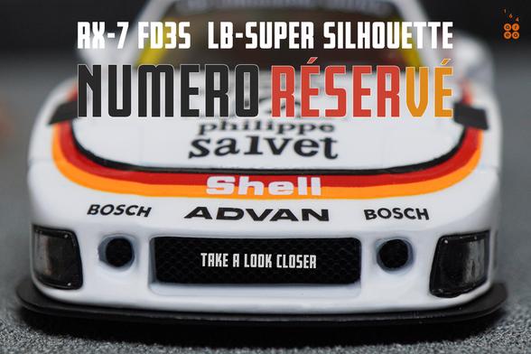 A close-up shot of Mazda RX-7 FD3S, LB-Super Silhouette, Numero Réservé livery by iNNO64 in 1:64 scale on AREA 164