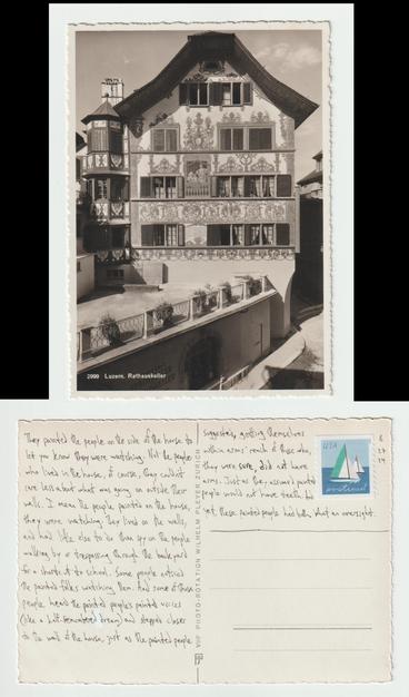 A postcard, front and back.

The front shows a decorated building in a German/European style with visible beams in the walls.

The back reads: They painted the people on the side of the house to let you know they were watching. Not the people who lived in the house, of course, they couldn't care less about what was going on outside their walls. I mean the people painted on the house, they were watching. They lived on the walls and had little else to do than spy on the people walking by or trespassing through the backyard for a shortcut to school. Some people noticed the painted folks watching them. And some of those people heard the painted people's painted voices (like a half-remembered dream) and stepped closer to the wall of the house, just as the painted people suggested, getting themselves within arms' reach of those who, they were sure, did not have arms. Just as they assumed painted people would not have teeth. And yet, these painted people had both. What an oversight.