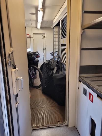 Open door to a technical room with a handful of bicycles.