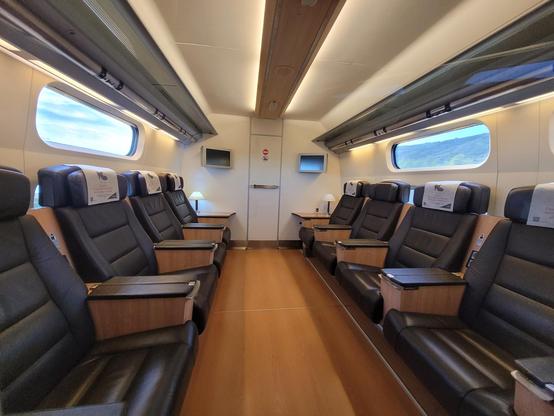 4 executive-looking seats along the sides of the train.