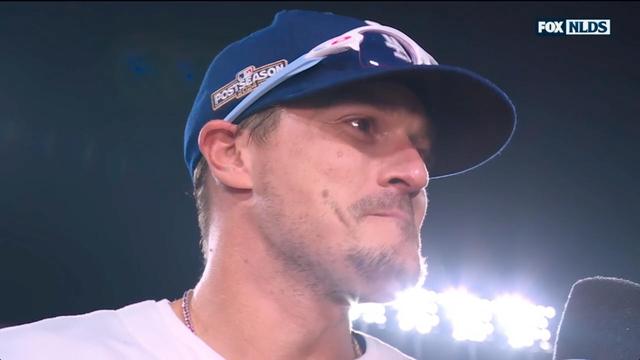 A close-up of a Kike Hernandez wearing a baseball cap, with a look of emotion on his face, during an interview with Ken Rosenthal. Bright stadium lights are visible in the background. His response to when Ken said they are live on air, was “The fact that we don’t give a fuck”. I hope he is ready to open up that wallet once FCC sends a certified letter of huge fine with profanity on over the air television during a family event. 