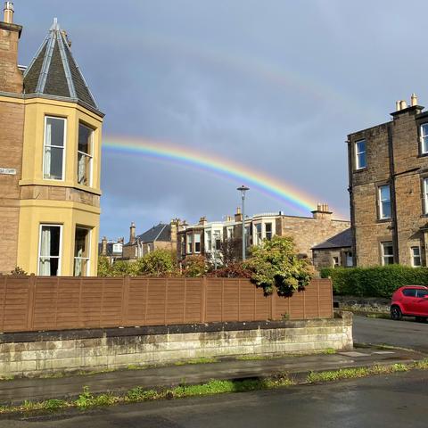 Bright rainbow with a faint double behind terraced houses in Morningside 