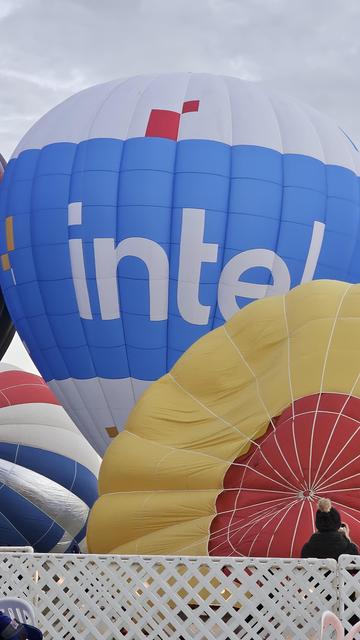 A large, mostly-inflated hot air balloon bearing the Intel logo