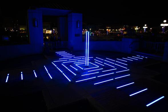 An installation of LED tubes set up as part of the Lumenaura event. They were blue at the time of taking this photograph, but the colors were constantly changing.