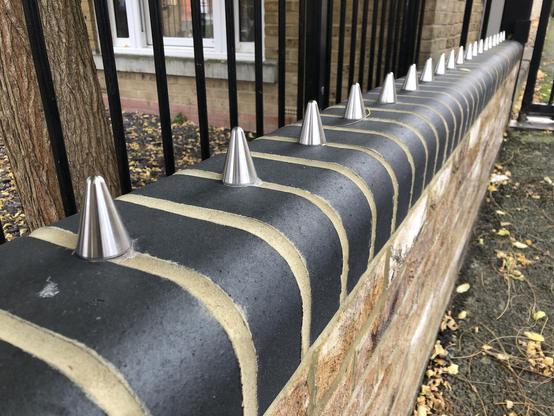 A small wall with metal spikes