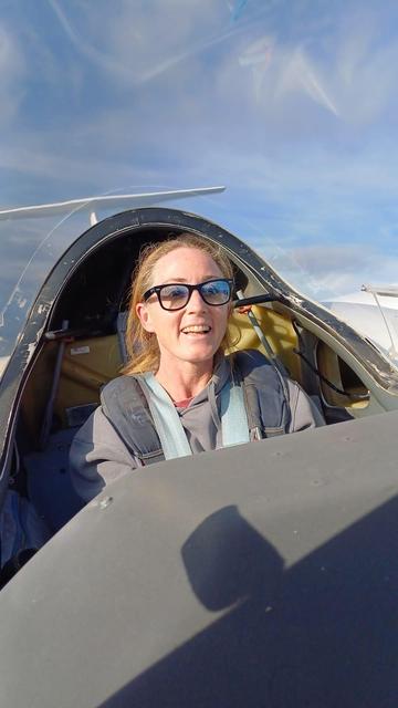 Me in the back seat of the glider, up in the sky, sun and big smile on my face.