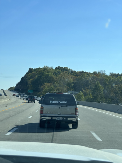 SUV with huge window sticker that just says “Tupperware”
