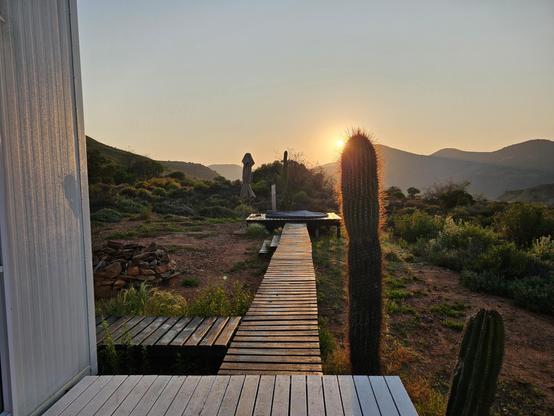 Early sunrise  with the hot tub and a cactus in the foreground