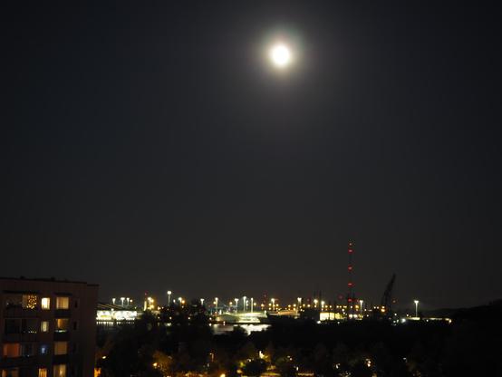 Der Hafen mit Beleuchtung, darüber steht der Mond
