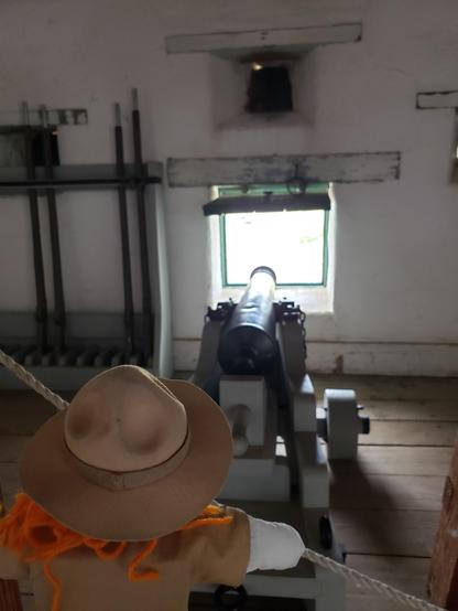 Ranger Sarah looks at the cannon located in the Southwest Bastion at Fort Union Trading Post.