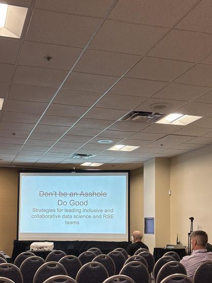 Slide on a projector with the text “Don’t be an asshole (scratched, followed by) Do good, strategies for leading inclusive research data team”