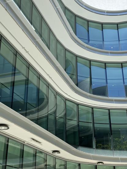 undulating, blue-green tinged floor to ceiling windows.