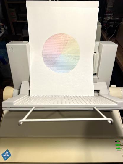 A linear color wheel printed as ASCII text on an ImageWriter II dot matrix printer with sheet feeder attachment. 