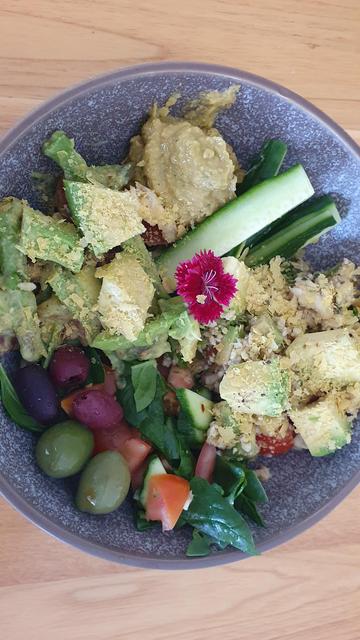 Asparagus, avocado, nutritional yeast. Salad. Broccomoli. Olives. In a bowl. 