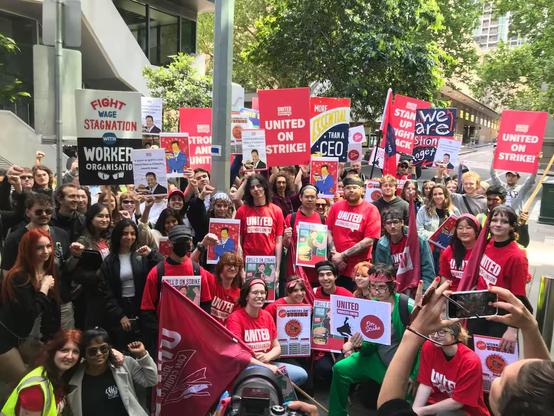 Members of United Workers Union STRIKE assembly outside Grill’d fast food industry site Flinders Lane in Melbourne CBD 
Workers in red UNITED shirts and supporters hold union flags/signs 
Fight wage stagnation with worker organisation.
United on Strike !
Stand Up Fight Back !