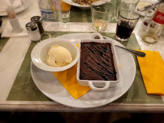 Chocolate souffle (right) with a bowl of vanilla ice cream (left)