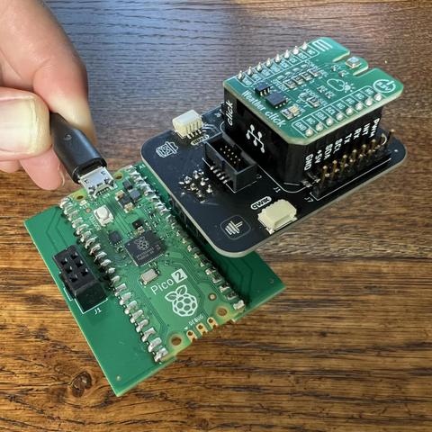 SAO Explorer simple add-on with a MikroE Weather Click board installed, plugged into a RPi Pico 2 board.