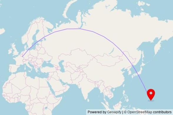 A map showing the great circle route from Differdange in Luxembourg to a map pin at Unupuker Church, Udot, Micronesia, United States of America