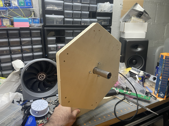The inner side of the hexagonal rack ear, being held up on my workbench surrounded by junk lol