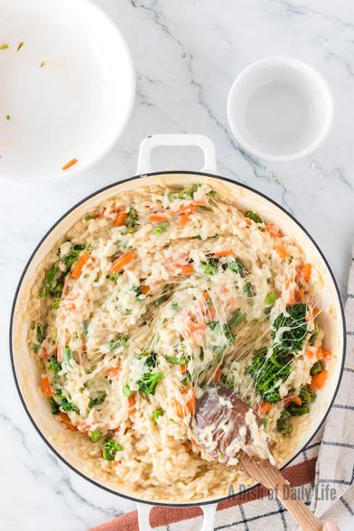 A pan of Easy Vegetable Risotto cooked and stirred with cheese melted. 

