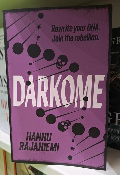 Hannu Rajaniemen kirja Darkome.
Kannessa on myös kommentti "Rewrite your DNA. Join the rebellion."