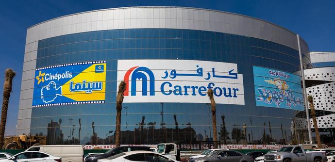 Shopping mall exterior wall and car park. 
Carrefour logo also in Arabic language 