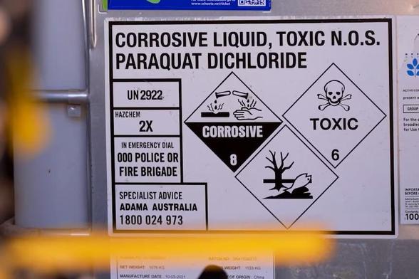 Warning sign
Text: CORROSIVE LIQUID, TOXIC PARAQUAT DIGHLORIDE 
UN2922 
Hazchem 2X
Corrosive 8
Toxic 6
In emergency dial 000 POLICE or FIRE BRIGADE 
Specialist Advice ADAMA AUSTRALIA
1800 024 973 

Images: skull and crossbones /poison logo 
Hand burned from spilling chemical 
Dead tree and dead fish 