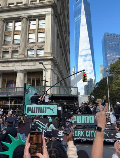 Breanna Stewart (holding baby Stewie and a microphone) on her float at the New York Liberty Championship Parade 🗽