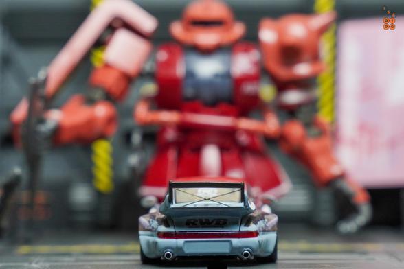 A rear side of Porsche RWB 964 Akiba by RWB Official in 1:64 scale with 1:64 figure on AREA 164
