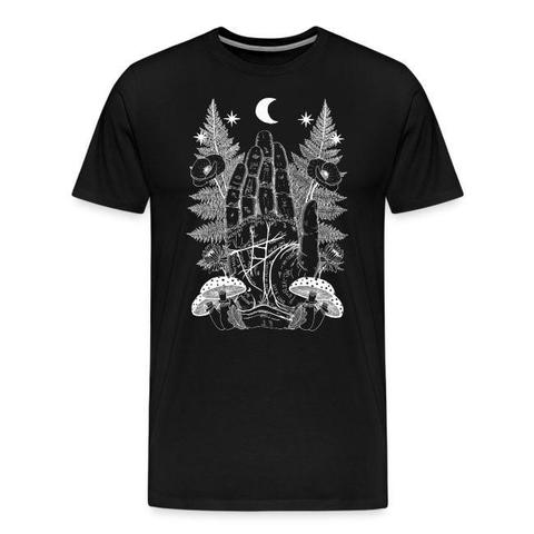 A black T-shirt with a white illustration on the front of a palmistry hand with a fern, a poppy, an aster, two fungi, and an oak leaf on either side. Across the top is an arch of stars with a crescent moon in the middle.