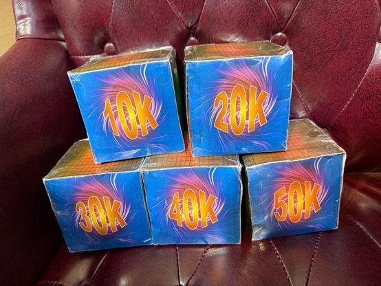 A set of five hand made boxes with images on each side and one face of each showing the word count goals from 10k to 50k. 