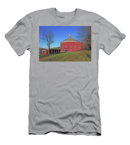 A grey t-shirt with a red round barn on the front.