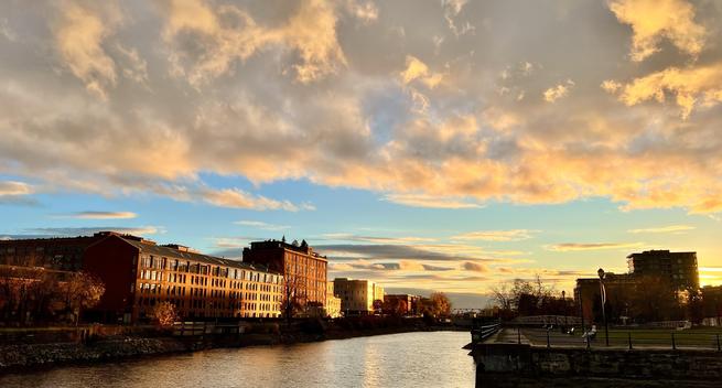 Cloudy sunset bouncing off buildings in front of the Lachine Canal in Griffintown, Montreal. Shot at 26mm with a vertical crop.
