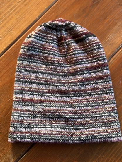 Green, brown, purple and light purple striped hand knitted hat 
