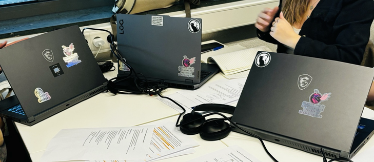Three laptops freshly adorned with stickers I grabbed for the three girls in my class at #Wiccon2024