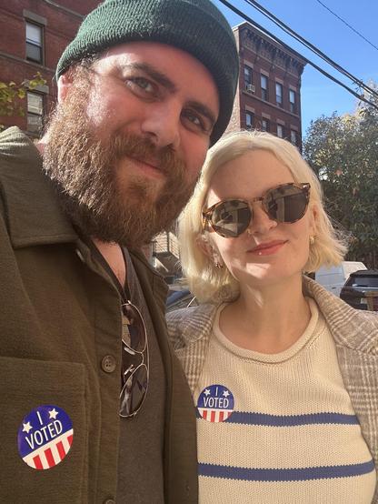 me and my partner, today in 2024, both with "I voted" stickers on our jackets.